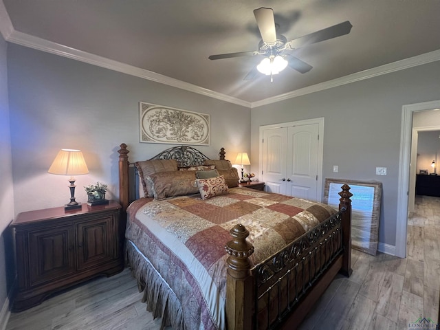 bedroom featuring hardwood / wood-style flooring, ceiling fan, ornamental molding, and a closet