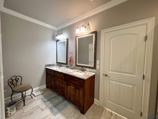 bathroom with crown molding, vanity, and an inviting chandelier