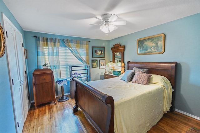 bedroom featuring ceiling fan, wood-type flooring, and a closet