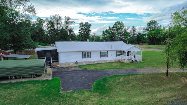 view of front of house featuring a front lawn and a sunroom