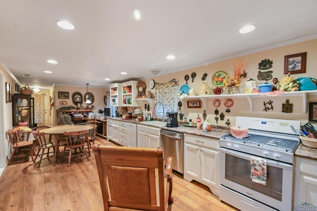 kitchen featuring light stone countertops, white cabinetry, sink, and stainless steel appliances