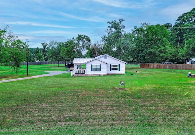 view of yard featuring a carport and a porch