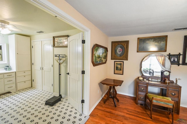 hallway with hardwood / wood-style floors