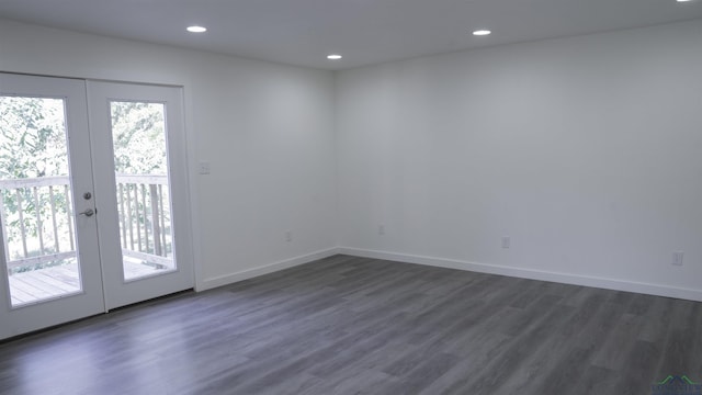 unfurnished room with dark hardwood / wood-style floors and french doors