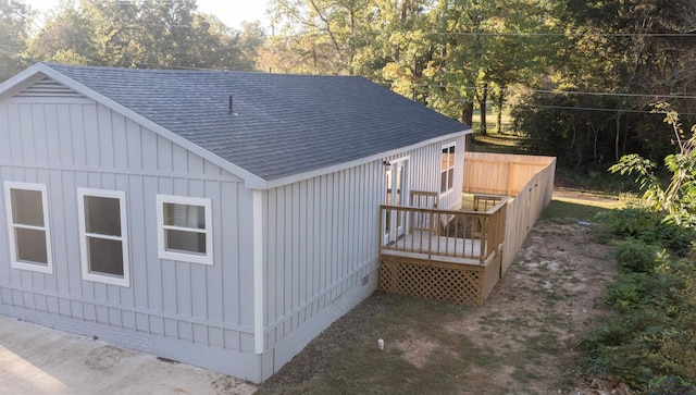 view of side of property with a wooden deck