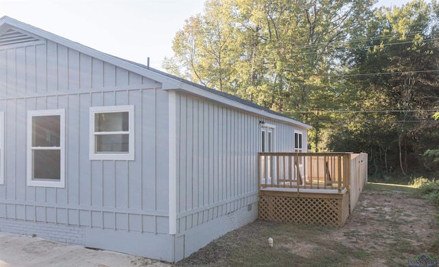 view of side of home with a wooden deck