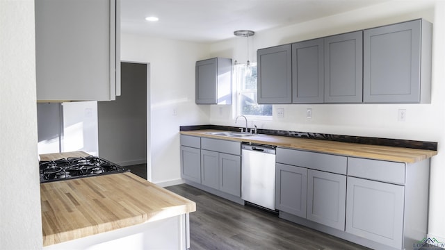 kitchen with wood counters, gray cabinetry, dark wood-type flooring, sink, and dishwasher