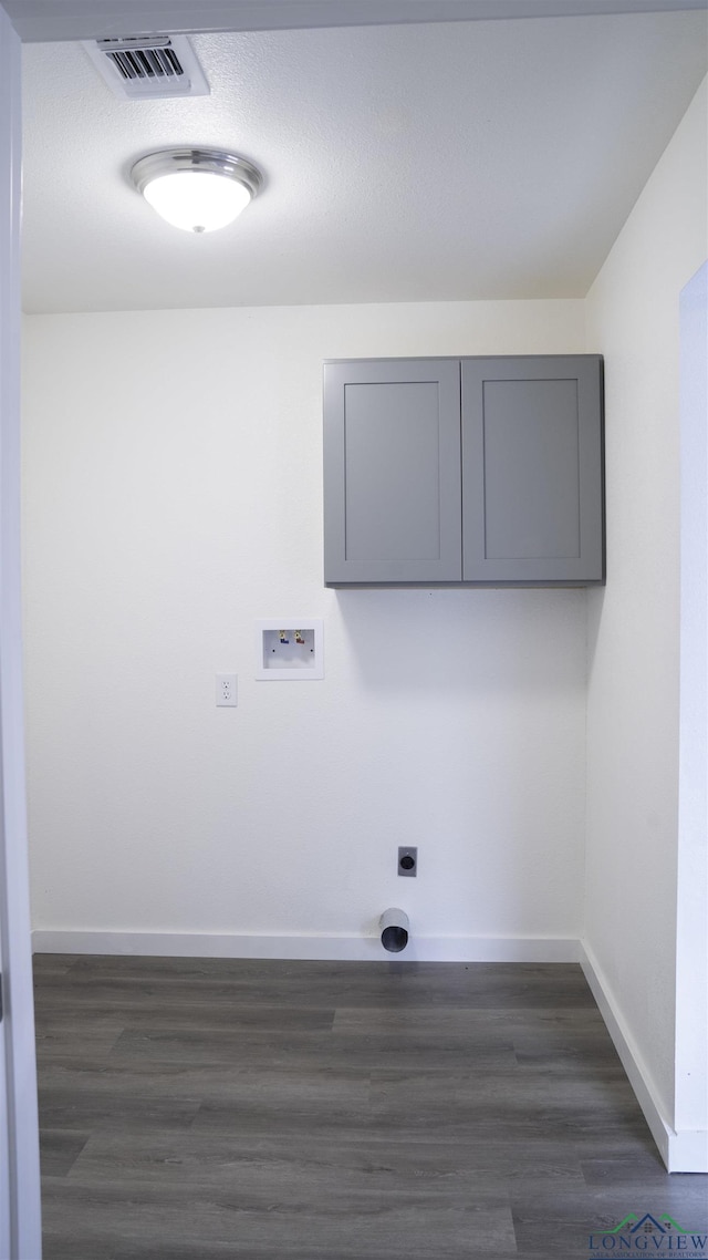 washroom featuring electric dryer hookup, cabinets, hookup for a washing machine, and dark wood-type flooring