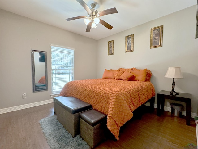 bedroom featuring ceiling fan and dark hardwood / wood-style floors