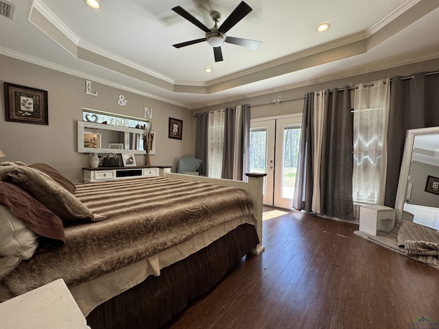 bedroom featuring dark hardwood / wood-style flooring, access to outside, a raised ceiling, and ceiling fan