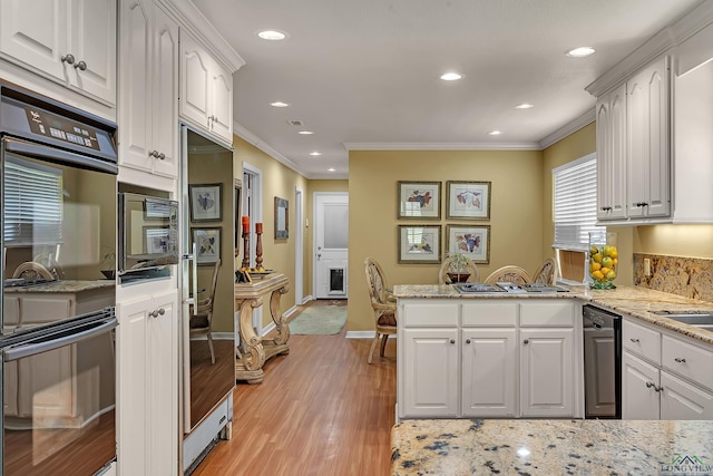 1303 Le Duke Blvd, Longview, TX 75601 - kitchen featuring crown molding, dishwasher, white cabinets, a peninsula, and light wood finished floors