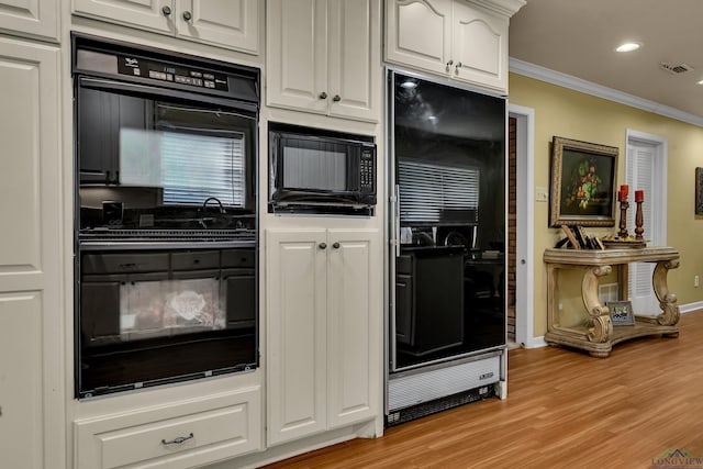 1303 Le Duke Blvd, Longview, TX 75601 - kitchen with black appliances, ornamental molding, white cabinets, light wood finished floors, and recessed lighting