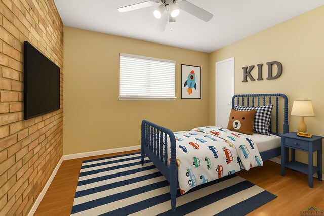 1303 Le Duke Blvd, Longview, TX 75601 - bedroom with wood finished floors, brick wall, and a ceiling fan