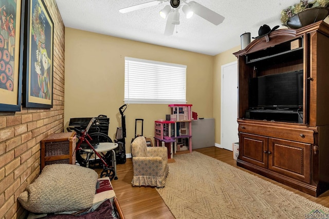 1303 Le Duke Blvd, Longview, TX 75601 - living area featuring a ceiling fan, wood finished floors, and a textured ceiling
