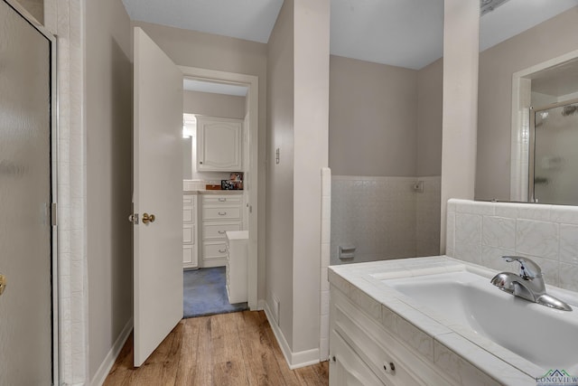 1303 Le Duke Blvd, Longview, TX 75601 - full bath featuring wood finished floors, a shower stall, and vanity