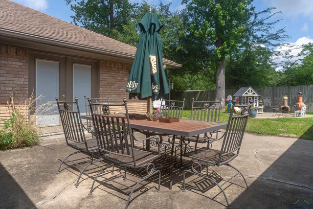 1303 Le Duke Blvd, Longview, TX 75601 - fenced backyard with outdoor dining space, a patio area, and a playground