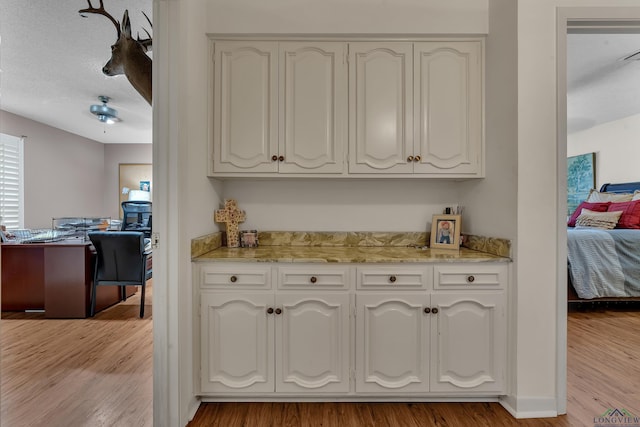 1303 Le Duke Blvd, Longview, TX 75601 - kitchen with white cabinets, light wood-style flooring, and an office area