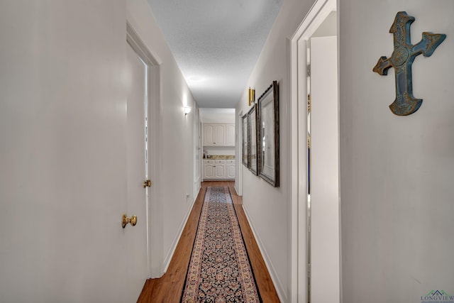 1303 Le Duke Blvd, Longview, TX 75601 - hall with wood finished floors and a textured ceiling