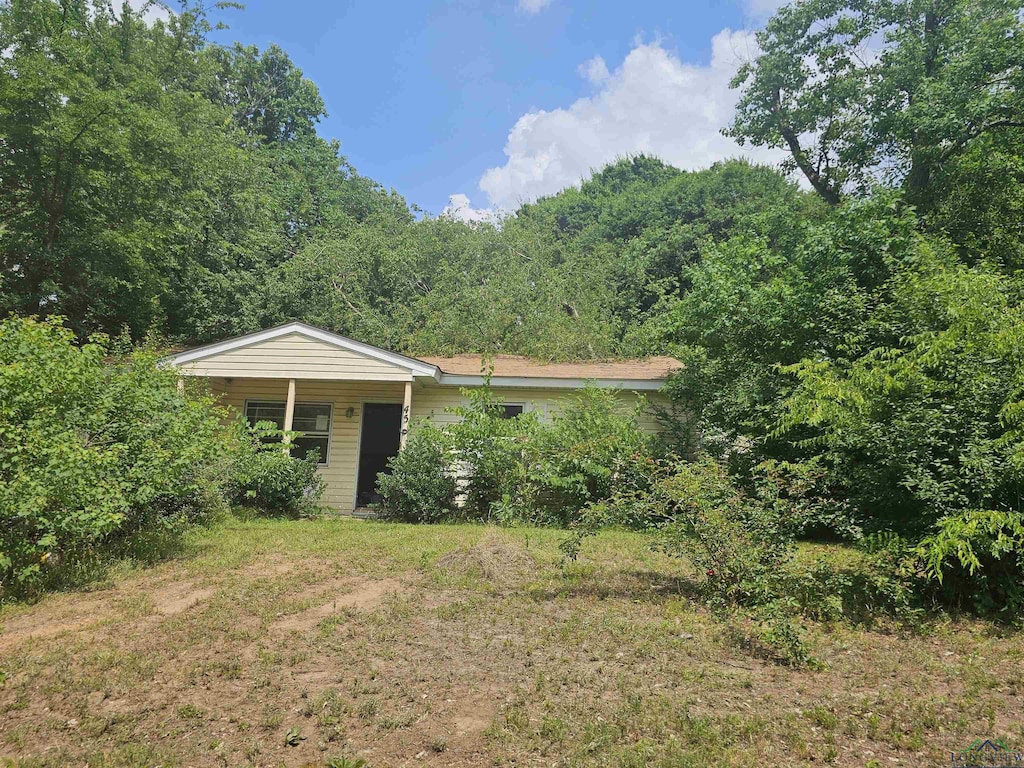 456 Bowie, Lone Star, TX 75668 - view of front of house with a wooded view