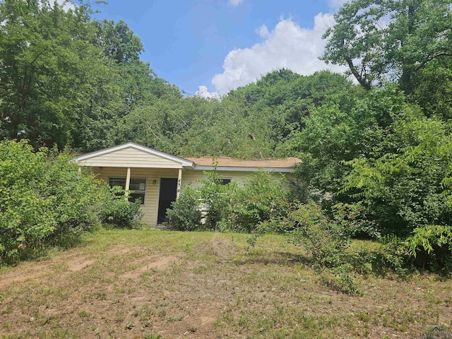 456 Bowie, Lone Star, TX 75668 - view of front of house with a wooded view