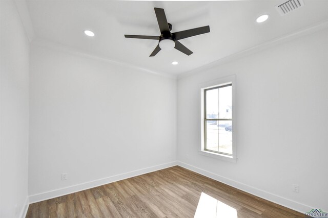 spare room featuring crown molding, ceiling fan, and wood-type flooring
