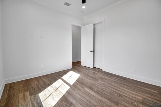unfurnished bedroom with hardwood / wood-style flooring, ceiling fan, and ornamental molding