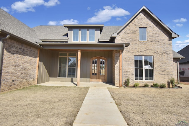 exterior space with french doors and a front yard