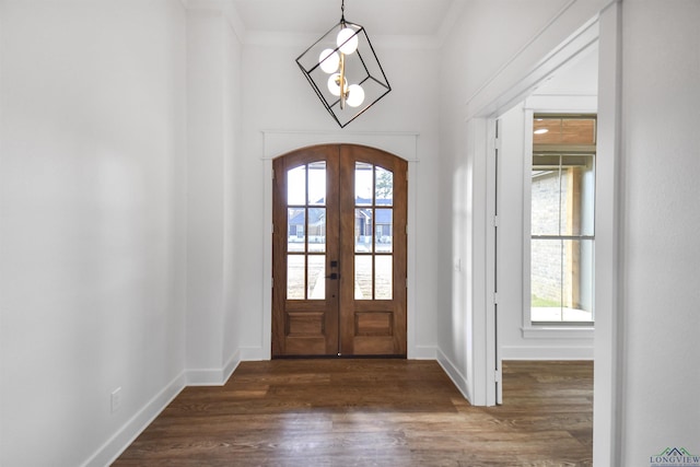 entrance foyer featuring dark hardwood / wood-style floors, a wealth of natural light, and french doors