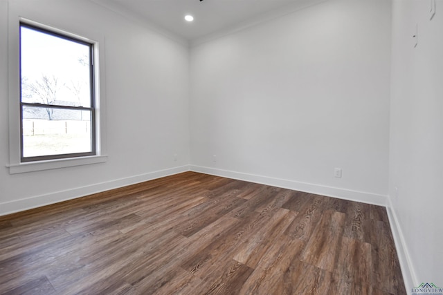 unfurnished room featuring crown molding and dark wood-type flooring