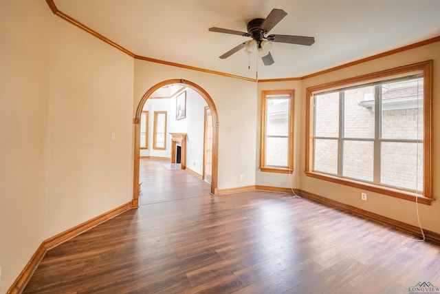 empty room featuring hardwood / wood-style flooring, ceiling fan, and crown molding