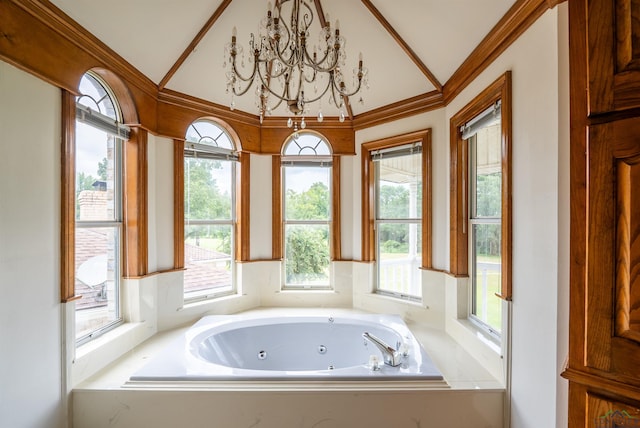 bathroom with a washtub, a chandelier, lofted ceiling, and ornamental molding