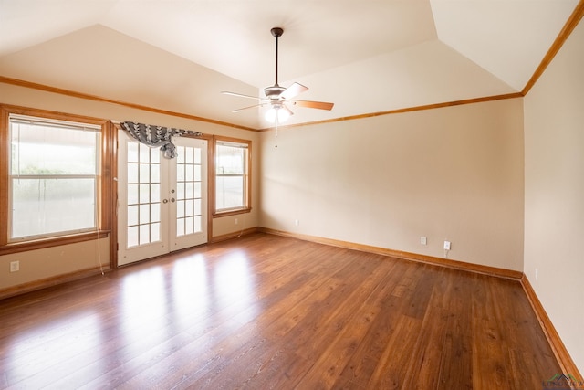 empty room with a wealth of natural light, ceiling fan, french doors, wood-type flooring, and lofted ceiling