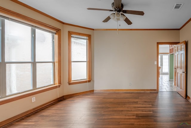 unfurnished room with a wealth of natural light, dark wood-type flooring, ceiling fan, and crown molding