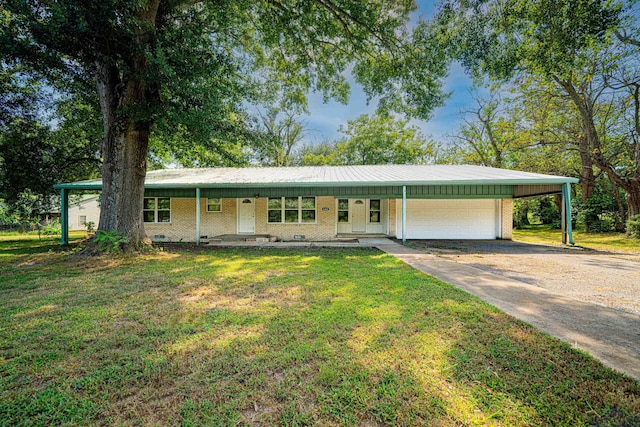 single story home featuring covered porch, a carport, a garage, and a front lawn