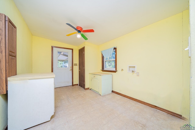 interior space featuring ceiling fan and cabinets