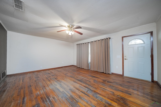 foyer entrance featuring a textured ceiling, dark hardwood / wood-style floors, and ceiling fan