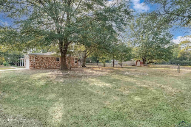 view of yard with a rural view