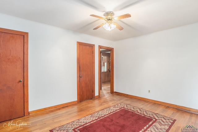 spare room featuring crown molding, ceiling fan, and light hardwood / wood-style floors