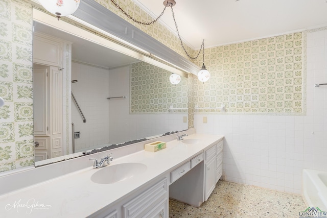 bathroom with vanity, a bath, and tile walls