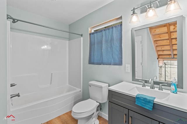 bathroom with toilet, vanity, bathtub / shower combination, and wood finished floors