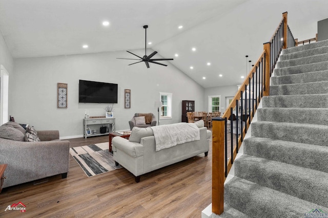 living area with stairway, wood finished floors, a ceiling fan, and recessed lighting