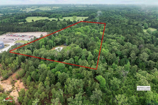bird's eye view featuring a wooded view