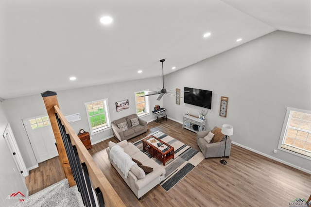 living area with wood finished floors, baseboards, ceiling fan, lofted ceiling, and recessed lighting
