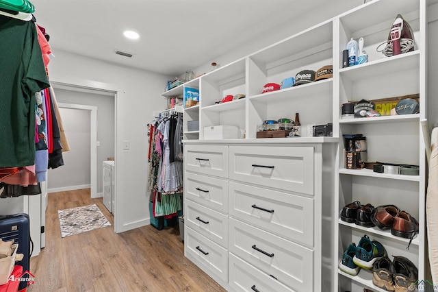 spacious closet featuring visible vents and light wood-style flooring