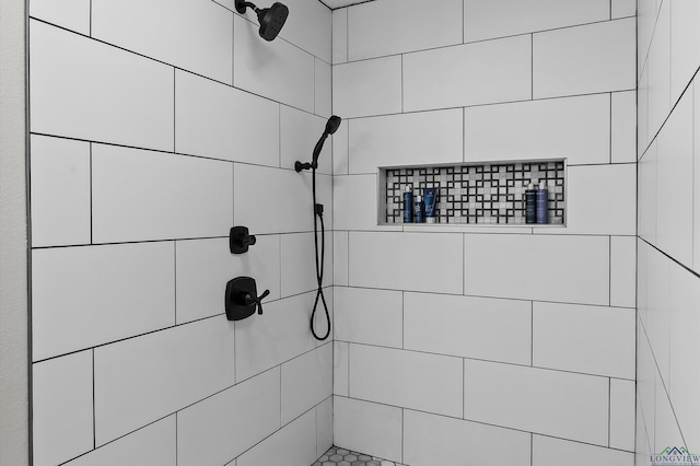 details featuring a tile shower and a package area