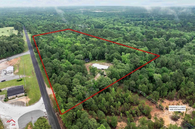 birds eye view of property with a wooded view
