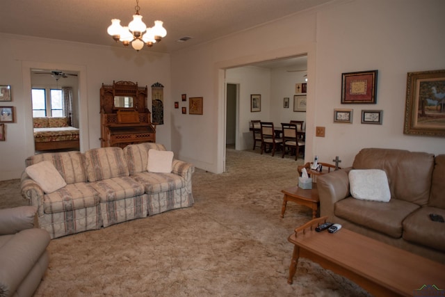 carpeted living room featuring crown molding and ceiling fan with notable chandelier