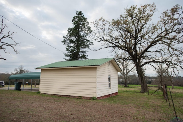 view of outdoor structure featuring a yard and a carport