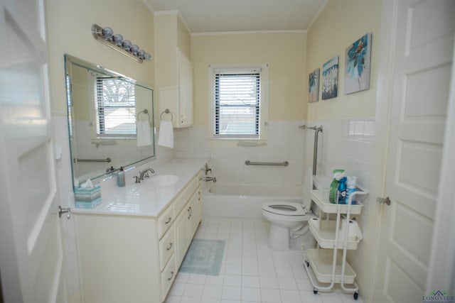 bathroom with a washtub, vanity, tile walls, tile patterned flooring, and toilet