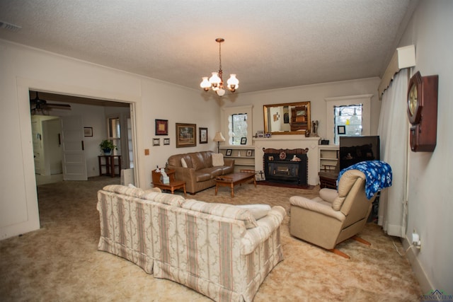 living room featuring ceiling fan with notable chandelier, crown molding, carpet floors, and a textured ceiling